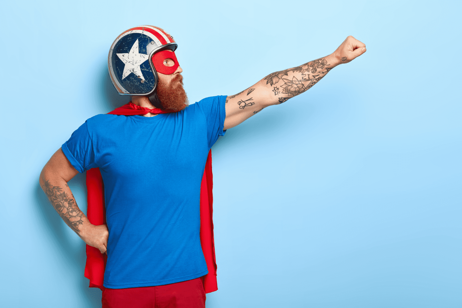 A man with helmet in Superman pose